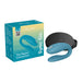 We-Vibe Sync Go couples vibrator in teal with black travel case and product packaging on white background.