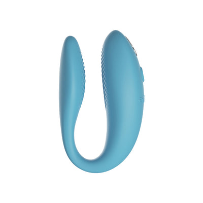 Blue ergonomic couples vibrator with textured inner arms and control buttons on the outer side.