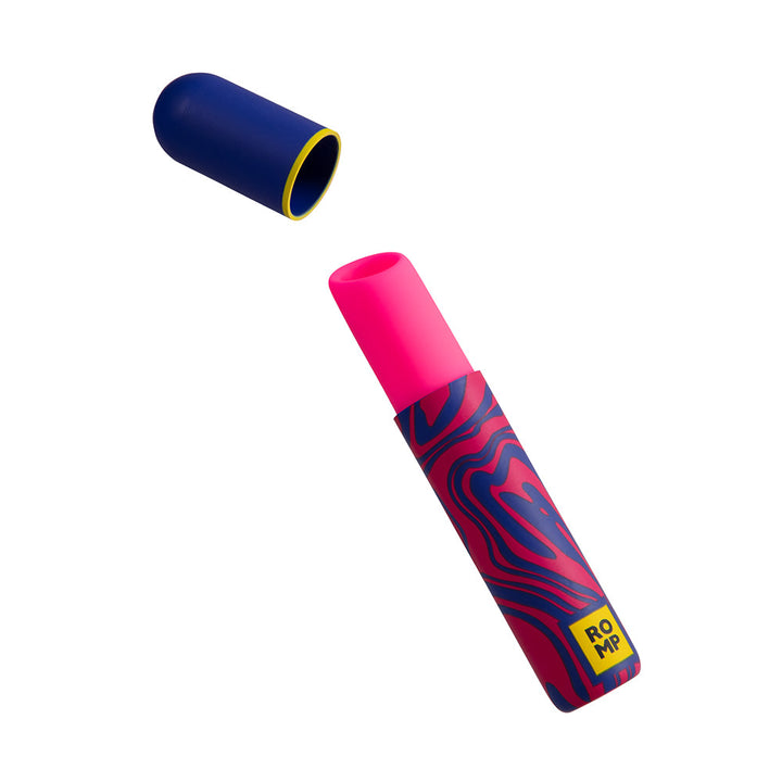 ROMP Pleasure Air Lipstick in vibrant pink with blue and red patterned casing and a blue cap with yellow trim.
