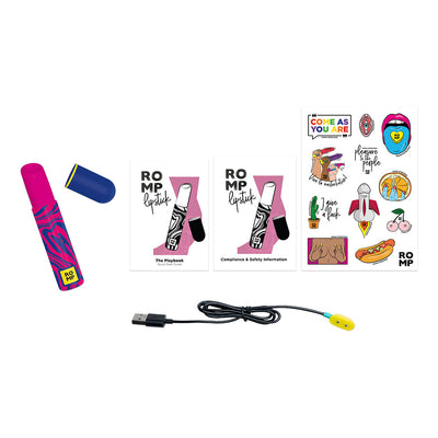 ROMP Pleasure Air Lipstick with cap, USB charging cable, quick start guide, safety info, and colorful sticker sheet.