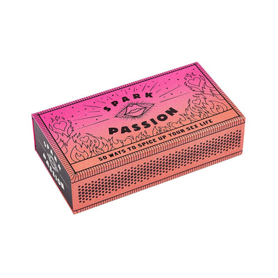 Decorative pink and orange matchbox-style box labeled Spark Passion with 50 ways to spice up your sex life.