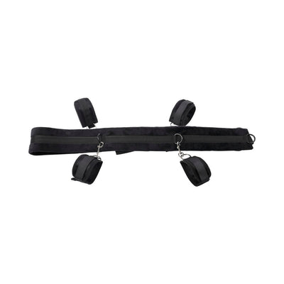 Black adjustable restraint system with padded cuffs and metal D-ring connectors on a white background.
