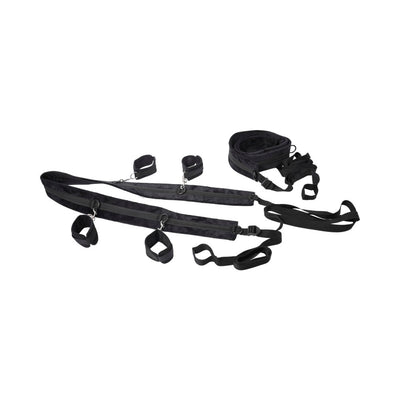 Black adjustable restraint system with padded straps and four attached cuffs for versatile positioning and secure fit.