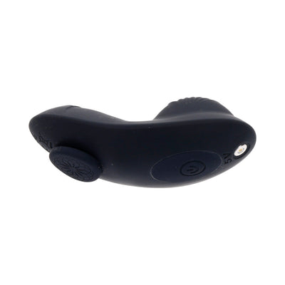 Black silicone remote control vibrator with curved ergonomic design and power button, part of a strap-on set.