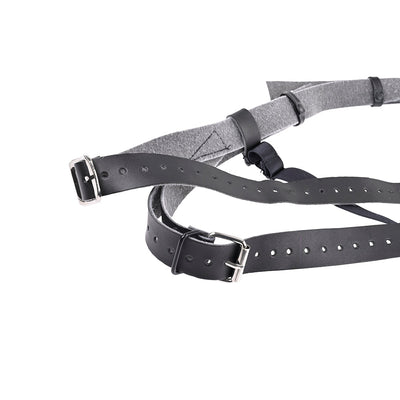 Close-up of black adjustable leather straps with silver buckles and grey fabric lining for a high-waisted strap-on harness.