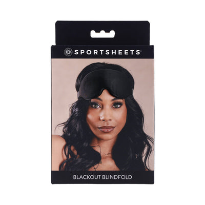 Packaging of Sportsheets Blackout Blindfold featuring a model wearing the black adjustable memory foam blindfold.
