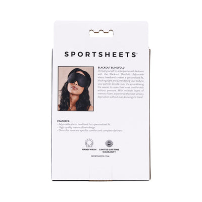 Packaging back of Sportsheets Blackout Blindfold with product description and image of a woman wearing the black blindfold.