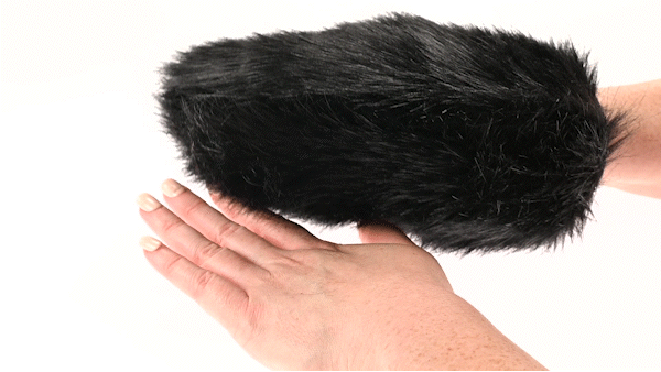 Black faux fur sensory mitt with hidden spikes, shown on hand for size and texture demonstration.