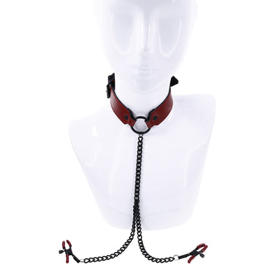 Red PU leather collar with black O-ring and attached black chain leading to adjustable red-tipped nipple clamps on a white mannequin bust.