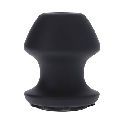 Small black silicone Kum Keeper with tapered shape and hollow center for easy filling and secure closure.