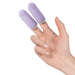 Hand wearing two lavender silicone fingertip massagers on index and middle fingers against white background.
