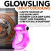 Pink translucent LED-lit rubber cocksling with stretch grip, shown next to a can for size reference.