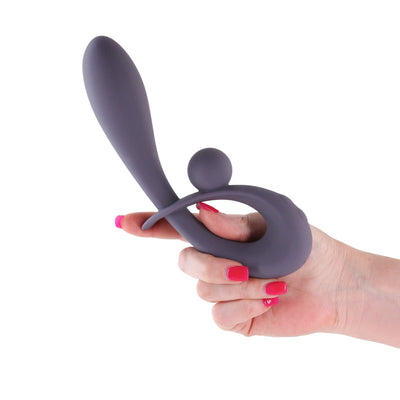 Hand holding a gray silicone rabbit vibrator with ergonomic design and dual stimulation features against a white background.