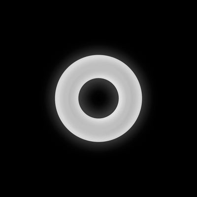 Glowing white Firefly Bubble Ring medium size made of soft silicone on black background.