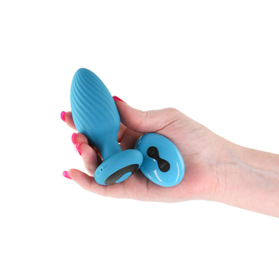 Hand holding a blue textured silicone anal plug and matching remote control with ergonomic design.