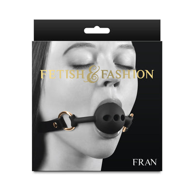 Packaging image of Fetish & Fashion Fran breathable black ball gag with adjustable strap and gold-tone hardware.