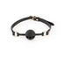 Black breathable ball gag with adjustable strap and gold-tone hardware on white background.