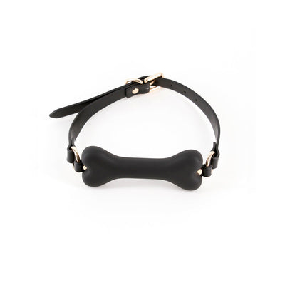 Black bone-shaped silicone gag with adjustable strap and gold-tone hardware on white background