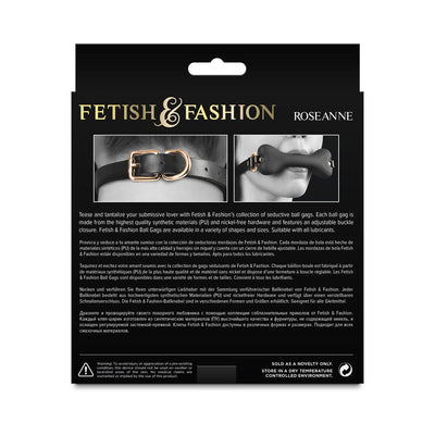 Back packaging of Fetish & Fashion Roseanne ball gag featuring close-up images of adjustable buckle and bone-shaped gag in black with gold hardware.