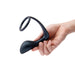 Hand holding a black silicone b-Vibe Ringer C-Ring and prostate plug with a flexible ring and curved base.