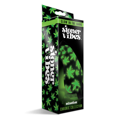 Packaging of Stoner Vibe Chronic Collection glow in the dark blindfold with green leaf pattern on black background.