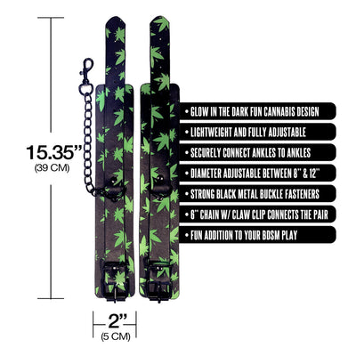 Glow in the dark ankle cuffs with green cannabis leaf design, adjustable black metal buckles, and connecting chain.