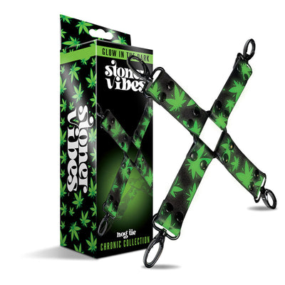Glow in the dark black hogtie with green cannabis leaf pattern and black metal clips next to matching packaging box.