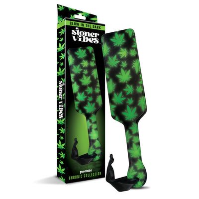 Glow in the dark paddle with green cannabis leaf design and black wrist strap, shown with matching packaging box.