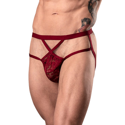 Male model wearing burgundy lace strappy jockstrap with elastic waistband and leg straps.