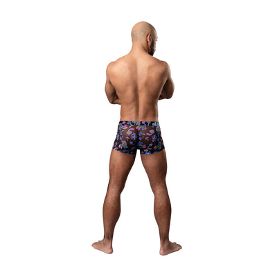 Rear view of a man wearing Male Power Hazy Dayz pouch shorts with colorful mushroom print on black fabric.