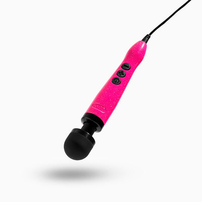 Compact Doxy Die Cast 3 wand vibrator in glittery hot pink with black silicone head and control buttons, connected by a power cord.