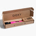 Doxy Die Cast 3 compact wand vibrator in hot pink with glitter, displayed in open branded cardboard packaging.