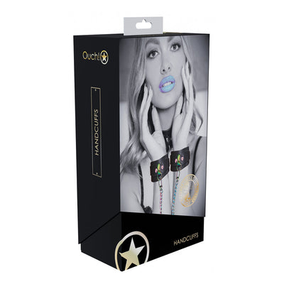 Packaging of Ouch! Venice Collection Handcuffs featuring a black and white image of a woman wearing leather handcuffs with iridescent hardware.
