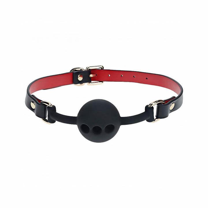 Black silicone ball gag with ventilation holes and adjustable black and red bonded leather straps with gold hardware.