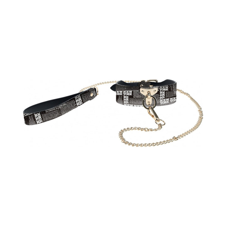 Black and white New York print collar with gold chain leash and matching wrist strap.