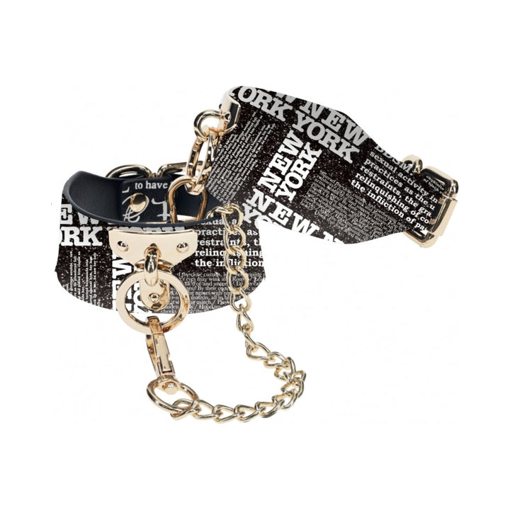 Black and white New York print leg cuffs with gold-tone chain and hardware, adjustable bonded leather design.