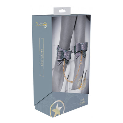 Packaging of Ouch! Paris Collection Leg Cuffs featuring iridescent ankle cuffs with decorative bows and a gold chain.