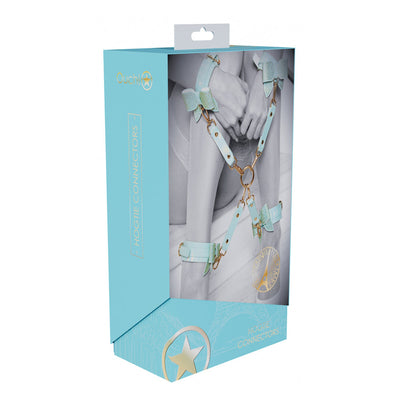 Packaging of Ouch! Paris Collection Hogtie Connectors in light blue with image of connected wrist and ankle cuffs in pastel blue and gold hardware.