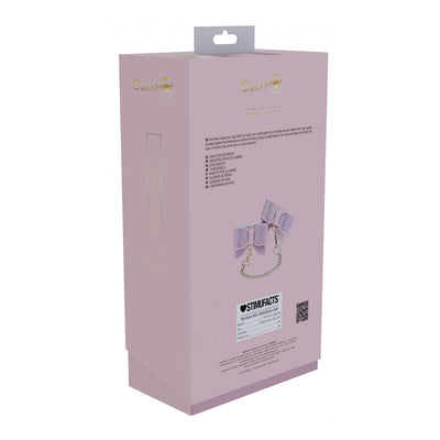 Packaging box of Ouch! Paris Collection Leg Cuffs in soft pink with gold lettering and product image on the back.