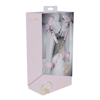 Packaging of Ouch! Paris Collection Hogtie Connectors showing pink bonded leather restraints with iridescent hardware on a model.