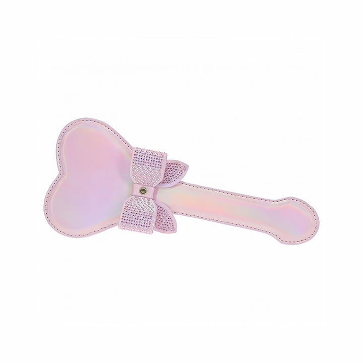 Iridescent pink heart-shaped paddle with rhinestone-studded bow detail on handle, stylish and sturdy design.