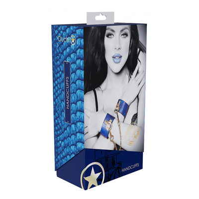Packaging of Ouch! Florence Collection Handcuffs featuring blue textured design and image of model wearing blue leather cuffs with gold hardware.