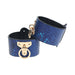 Pair of blue faux snakeskin handcuffs with gold-tone iridescent hardware and padded black interior lining.