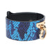 Blue snakeskin-patterned leather cuff with gold-tone hardware and a sturdy O-ring detail.