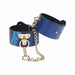 Blue faux snakeskin leg cuffs with gold-tone chain and hardware, adjustable and stylish restraint accessory.