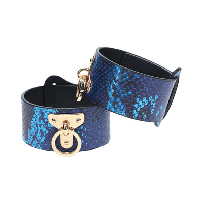 Blue iridescent snake-print leg cuffs with gold-tone hardware and adjustable straps from the Ouch! Florence Collection.