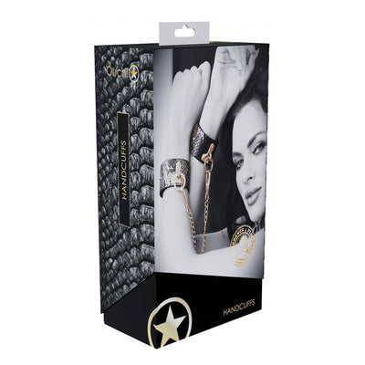Packaging of Ouch! Florence Collection Handcuffs featuring a black and iridescent leather design with gold chain and hardware.