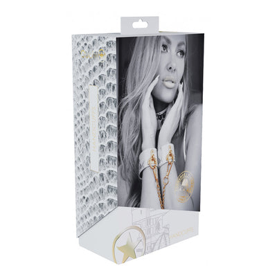 Packaging box for Ouch! Florence Collection Handcuffs featuring a black and white image of a woman wearing white leather handcuffs with gold hardware.