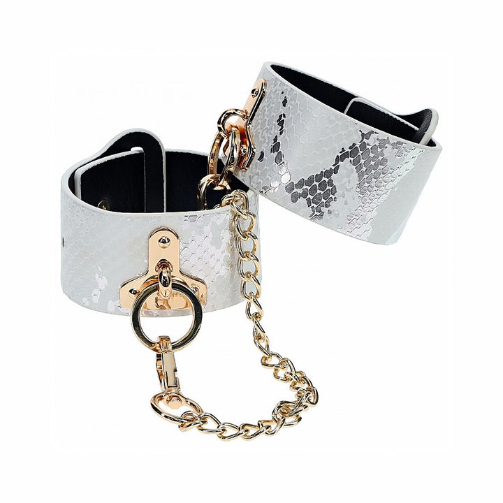 White snakeskin textured leather handcuffs with gold-tone chain and hardware from the Ouch! Florence Collection.