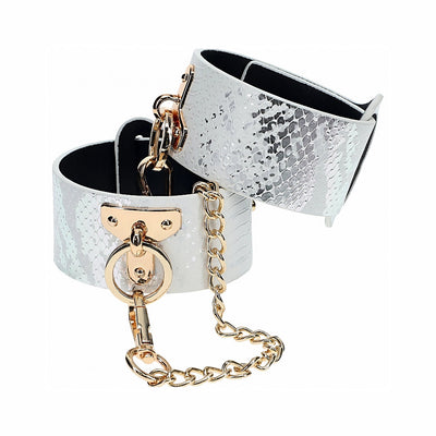 White faux snakeskin leg cuffs with gold-tone chain and hardware, adjustable and stylish restraint accessory.